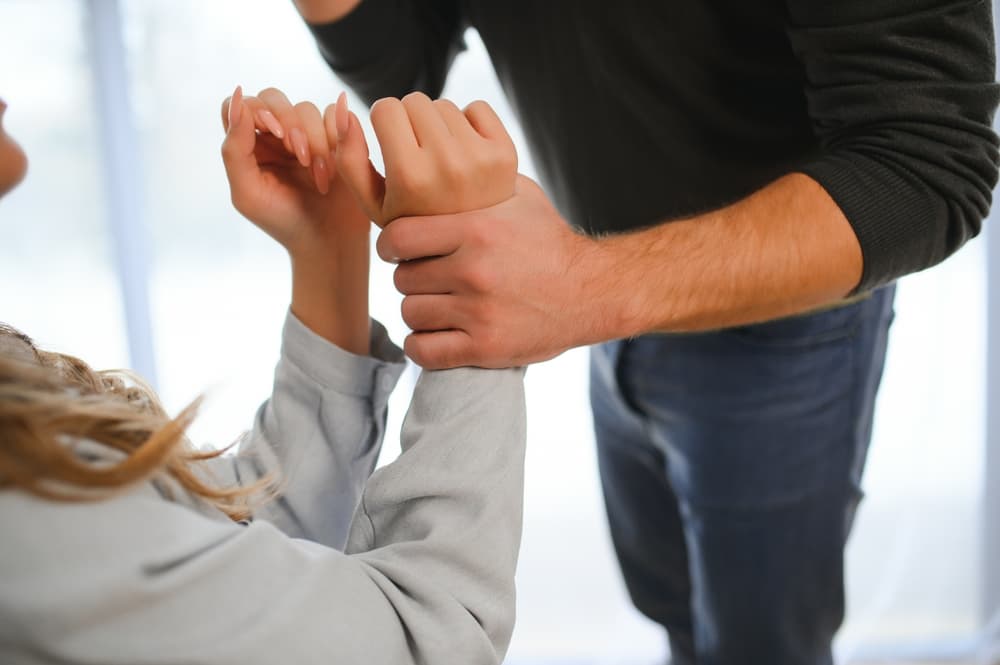 Man beating up his wife illustrating domestic violence