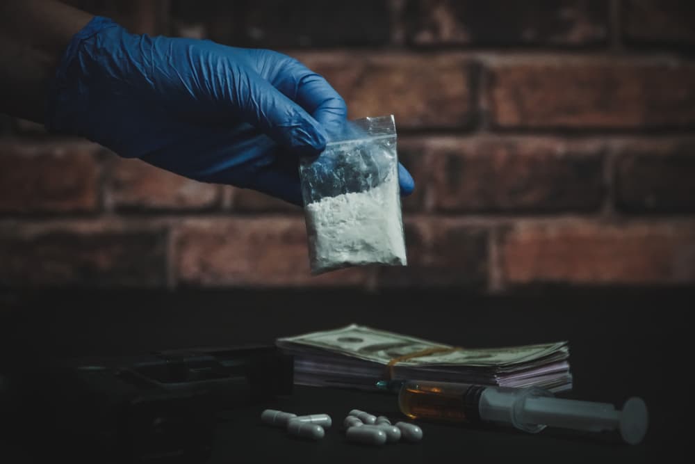 Policeman holding drugs in hand