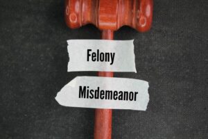 Judge's hammer and stickers with the words felony and misdemeanor 