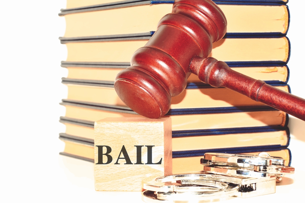 Wooden cubes arranged to spell the word BAIL on a white background, representing the bail concept.